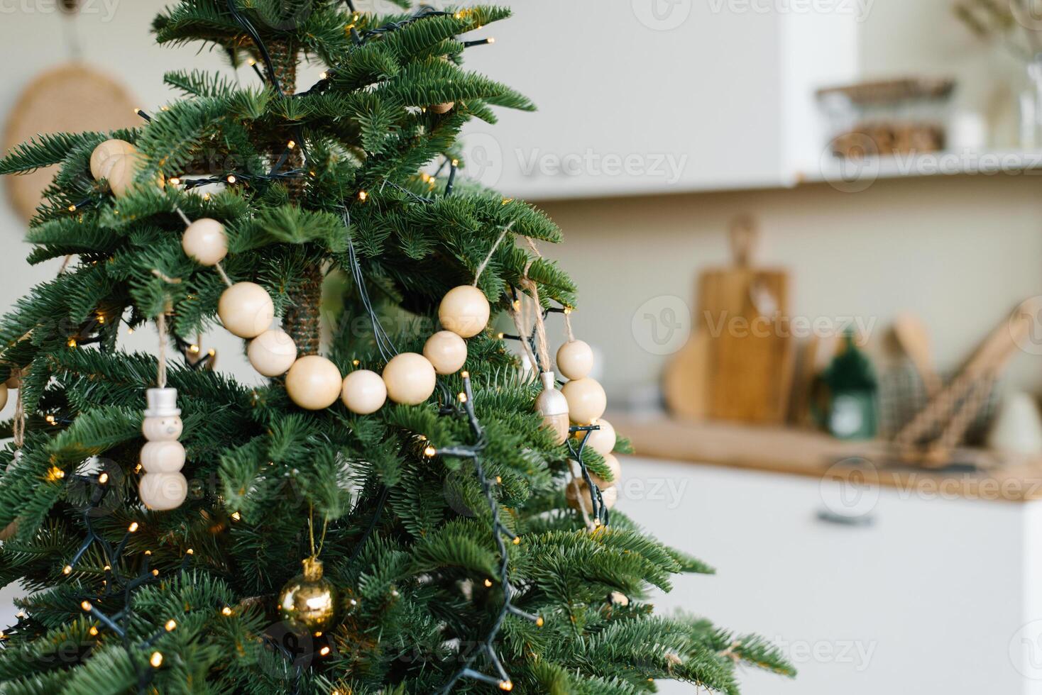 Stylish wooden beads on a Christmas tree in the dining room of a Scandinavian home photo