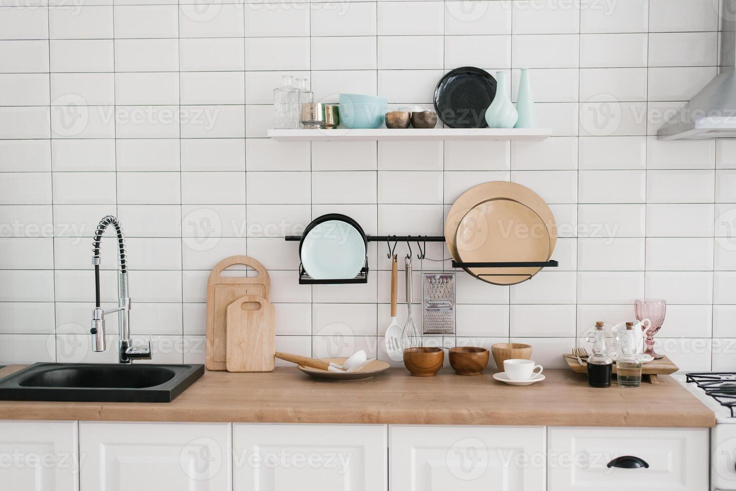 Kitchen utensils and utensils in the bright white wooden kitchen photo