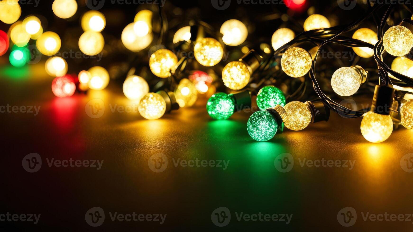 Glowing yellow, green, and red string lights spread across a dark surface. Festive and decorative lighting for holiday and seasonal designs. Copy space photo