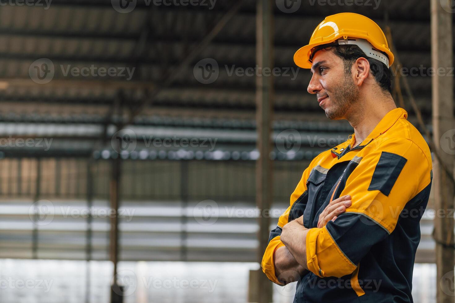 Caucasian engineer using a laptop in a factory. man working in plastics factory. photo