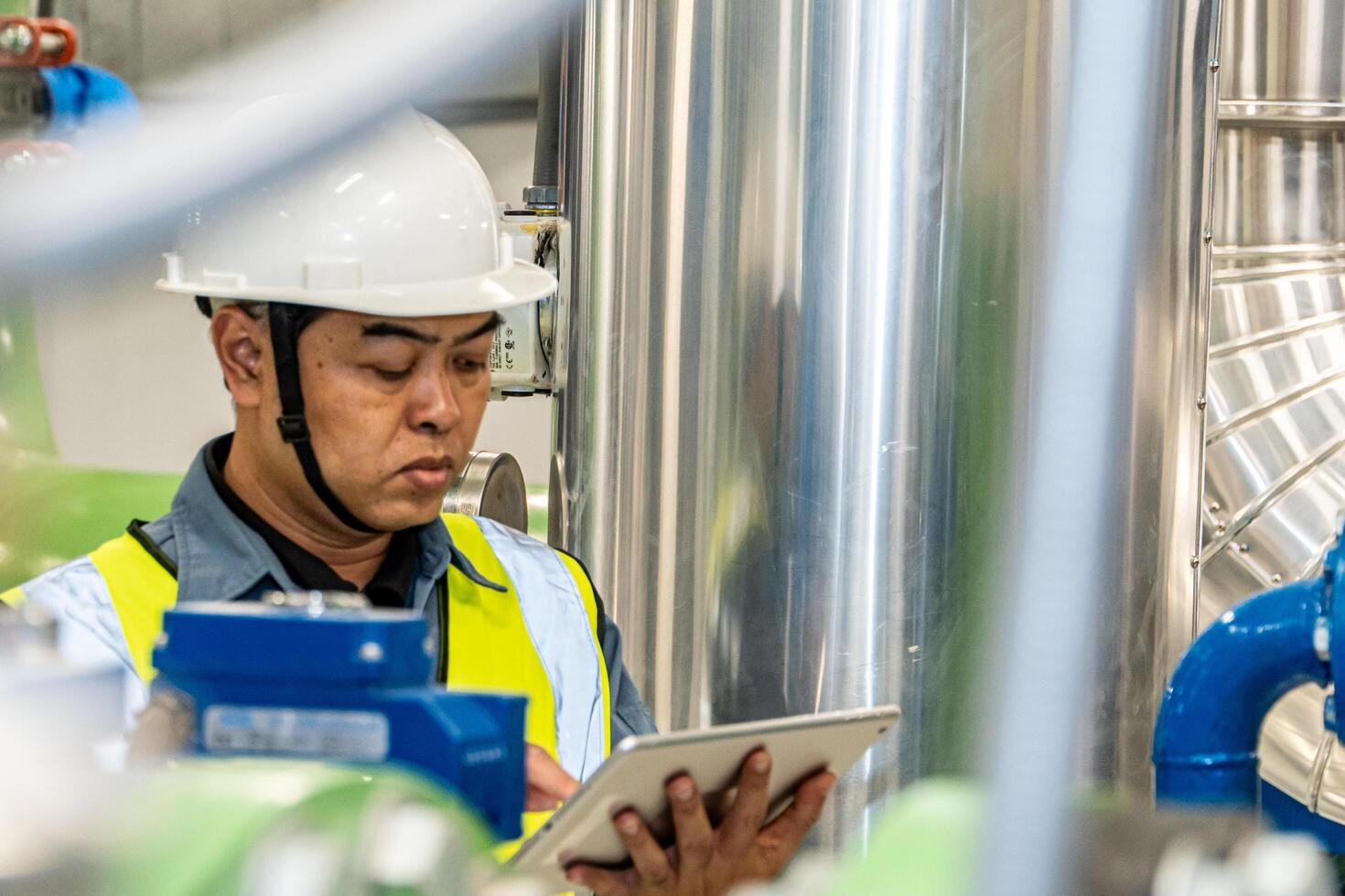 asian man factory technologist. Industrial worker. Chemical plant specialist. photo