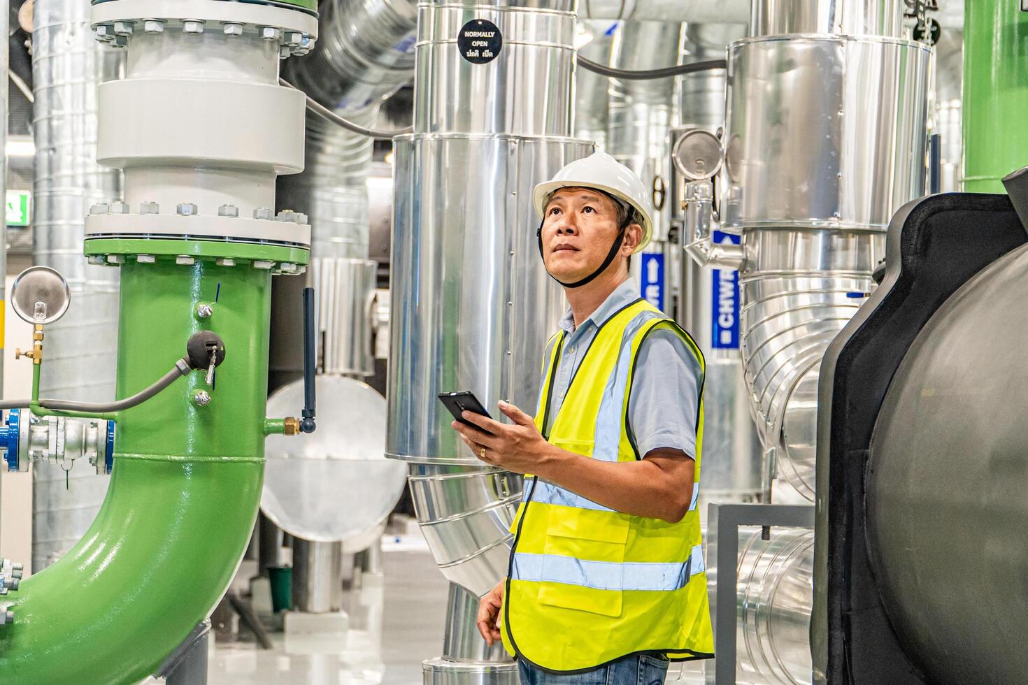 asian man factory technologist. Industrial worker. Chemical plant specialist. photo