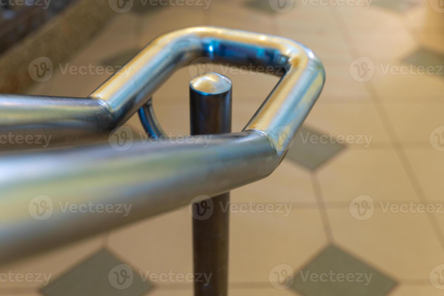 A close-up view of a metal handrail attached to a post photo