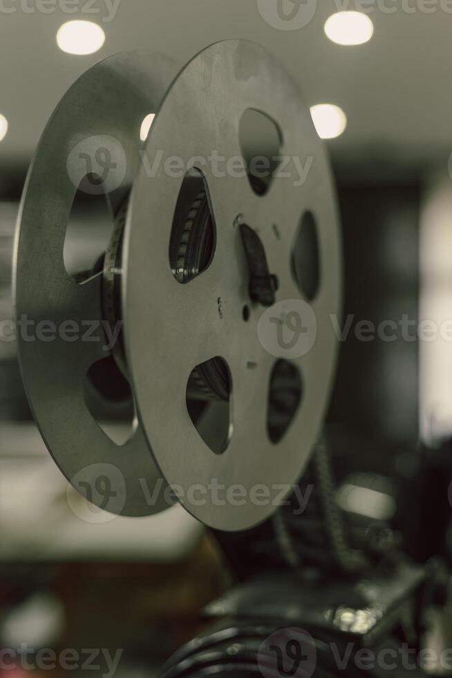 A close-up view of a film reel in a projector, showcasing the intricate details of the mechanism that brings movies to life photo