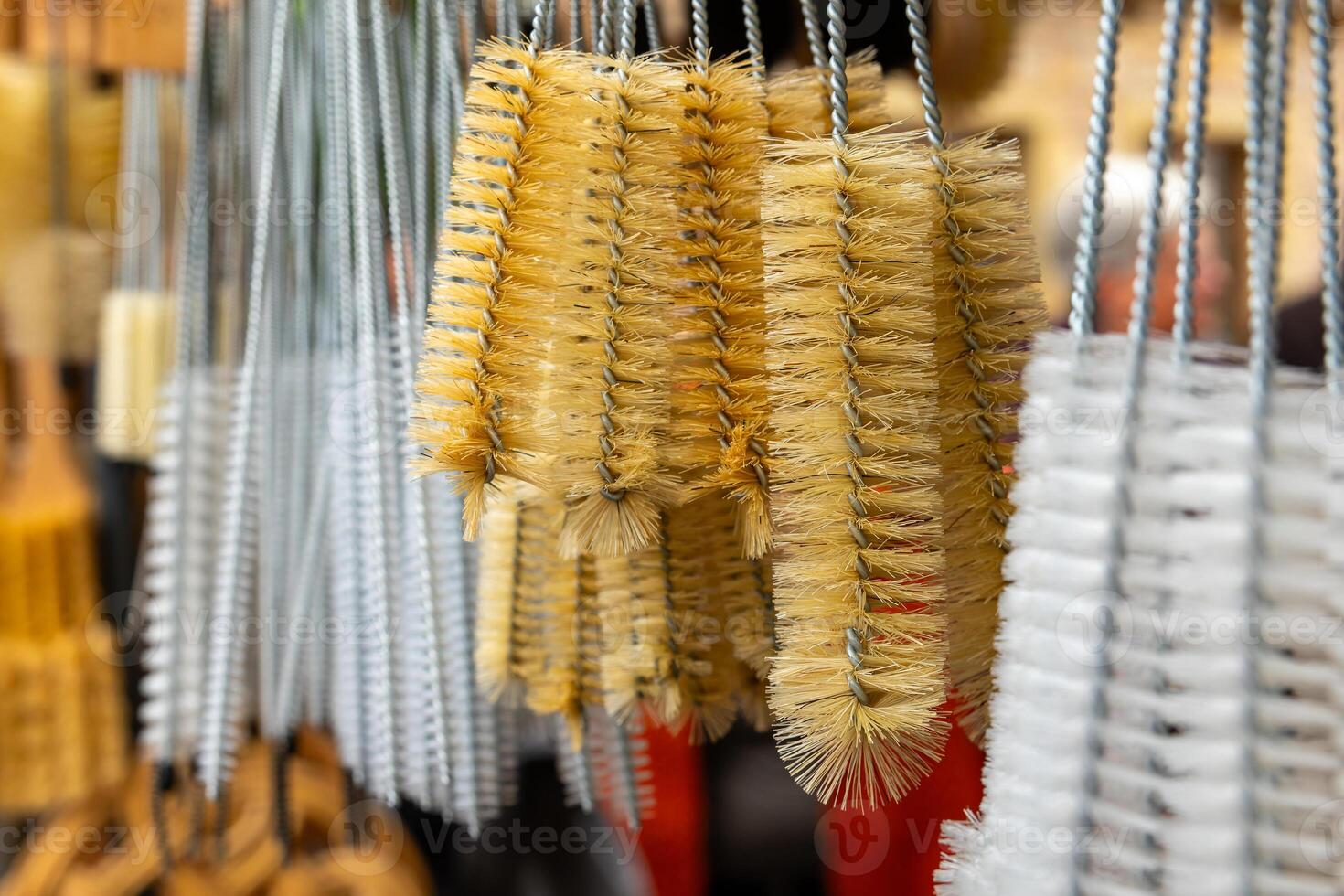 A close-up of cleaning brushes hanging in a store, ready for cleaning up spills and messes photo