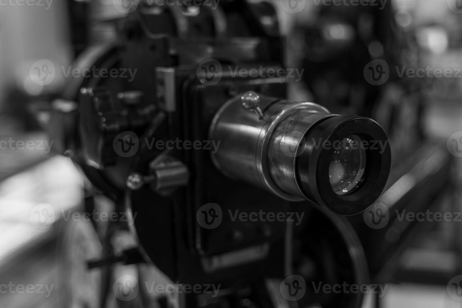 A vintage film projector lens is positioned for viewing, ready to project a classic film photo