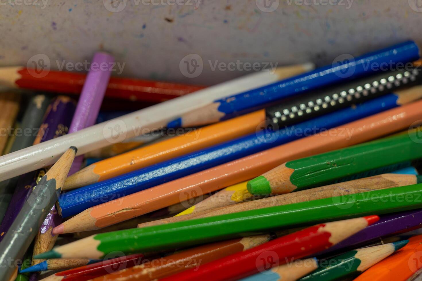 A close-up of a colorful assortment of pencils in a container photo