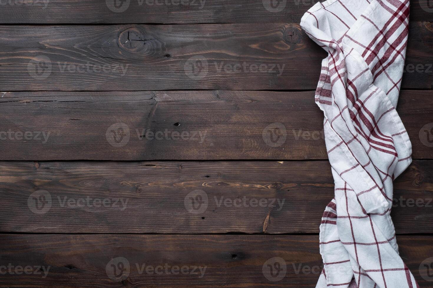 Textile napkin kitchen towel. Wooden rustic table background. Copy space. photo