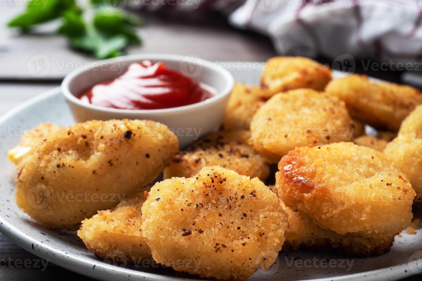 Fried chicken nuggets with tomato ketchup sauce. Wooden background. Copy space. photo
