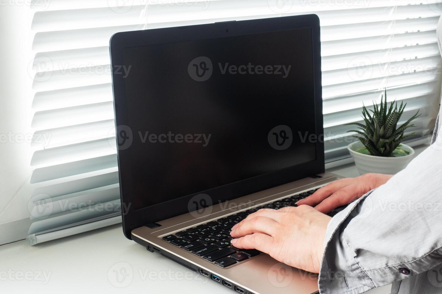Woman working at computer hands at home. Concept of working and learning at home. Copy space. photo