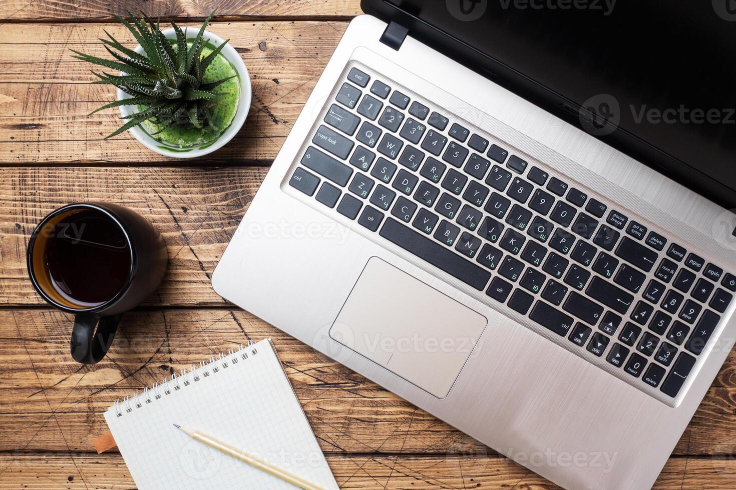 Working wooden table at home or in the office. Computer laptop coffee cactus. Flat lay conceptions Copy space. photo