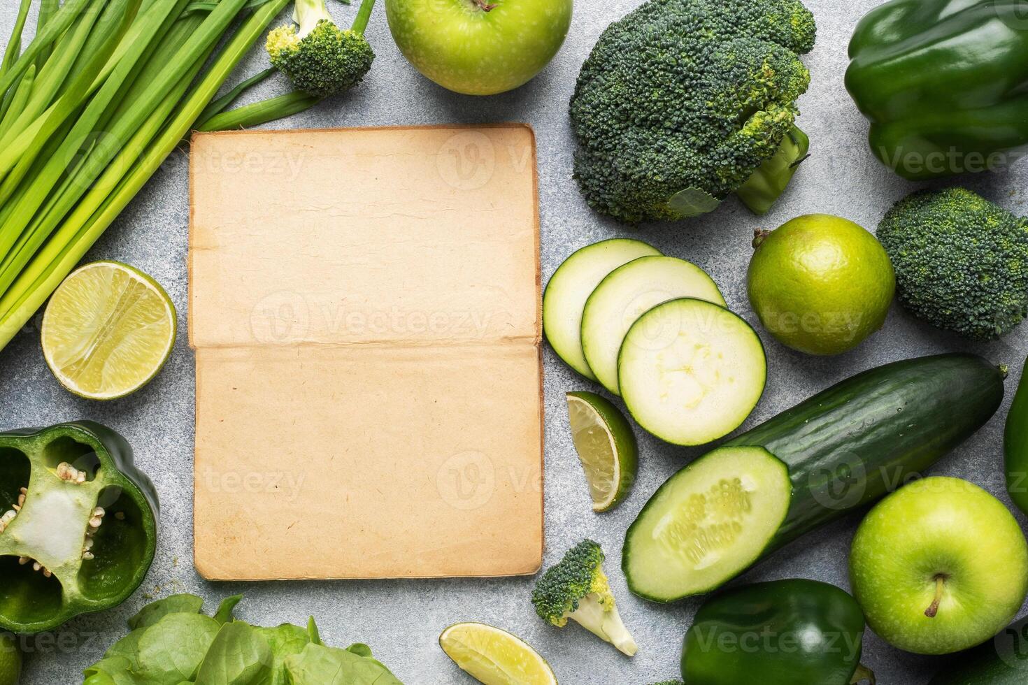Frame Fresh green vegetables and herbs on a grey concrete background. Copy space. photo