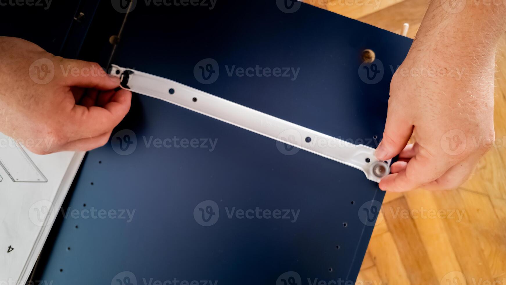 Hands assembling furniture at home, emphasizing DIY and home improvement concepts photo