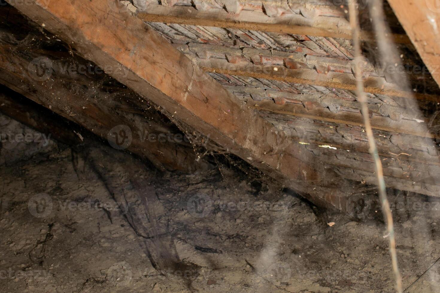 Dusty attic with cobwebs and wooden beams, perfect for haunted Halloween scenes or neglected property concepts photo