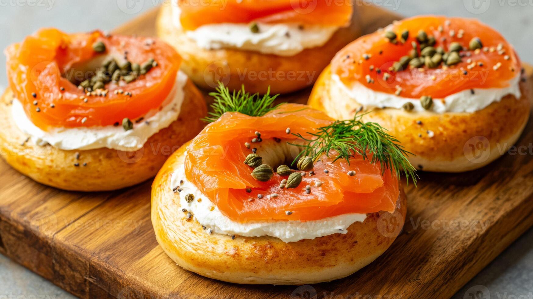 Freshly baked bagels with cream cheese smoked salmon slices dill and capers arranged beautifully on a wooden serving board photo
