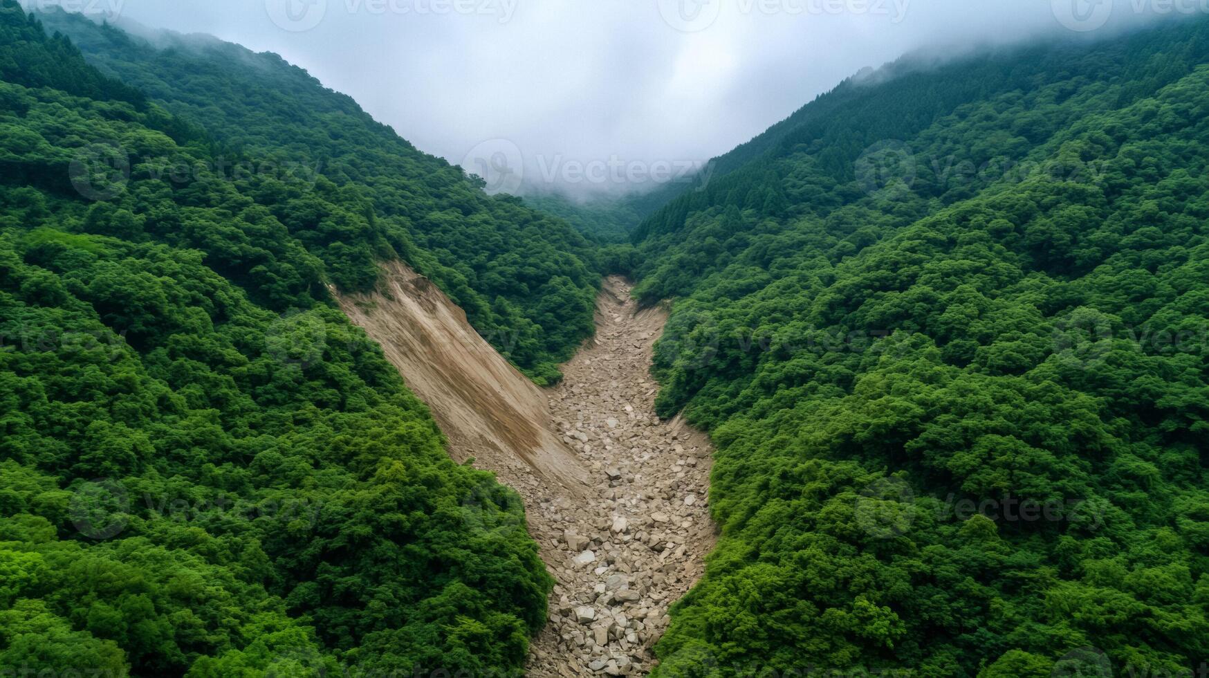 Massive landslide crushing a mountainside rocks and debris sliding down violently through dense green forest photo