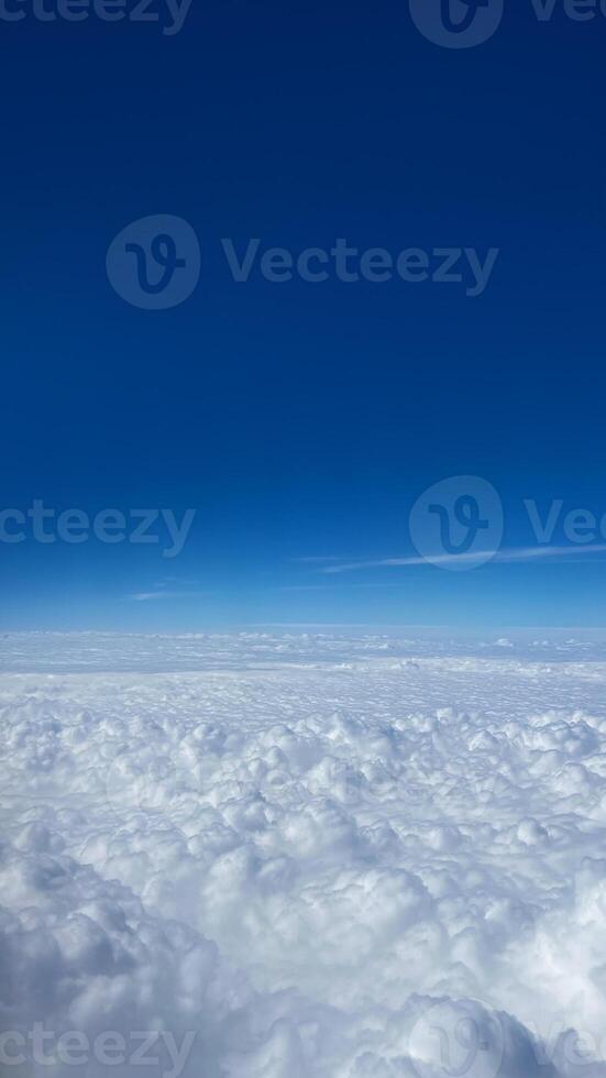 A serene view of fluffy white clouds against a vibrant blue sky, embodying concepts of freedom and travel inspiration photo