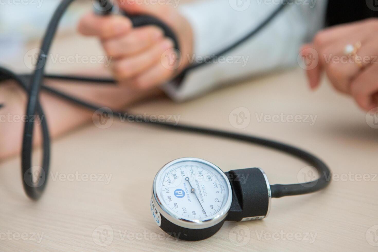 Doctor measuring blood pressure of patient in hospital. Medical and healthcare concept. photo