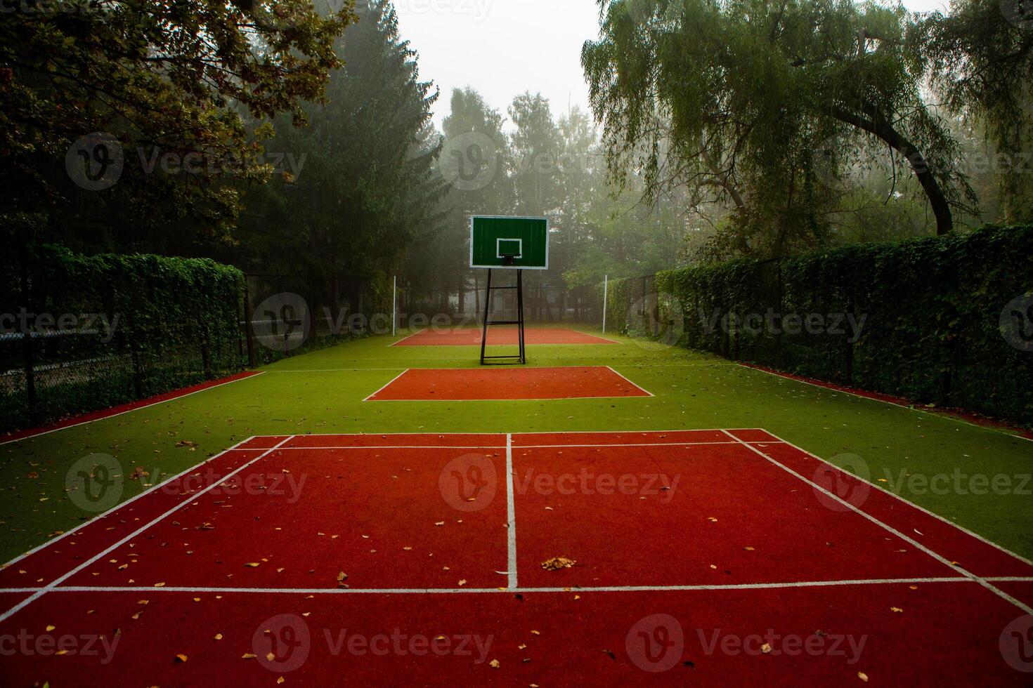 Empty tennis court in foggy morning at public park. sport background concept. photo