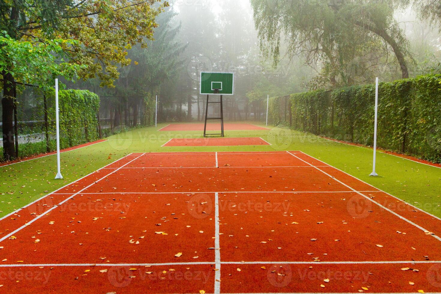 Empty tennis court in foggy morning at public park. sport background concept. photo