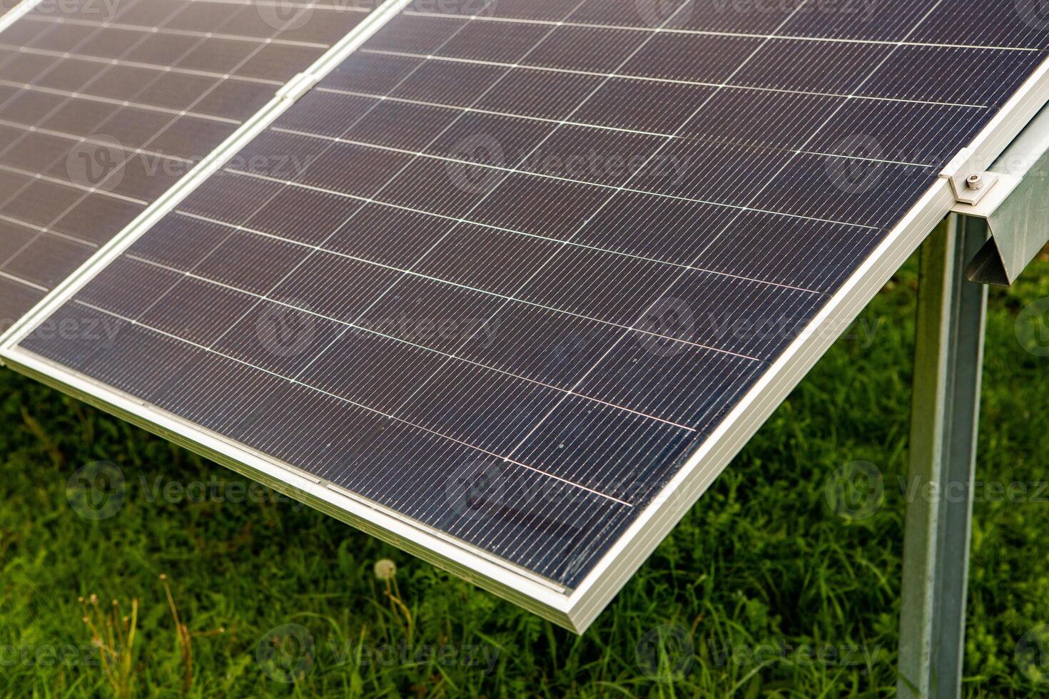 Solar panel on green grass background, Alternative energy from the sun. photo