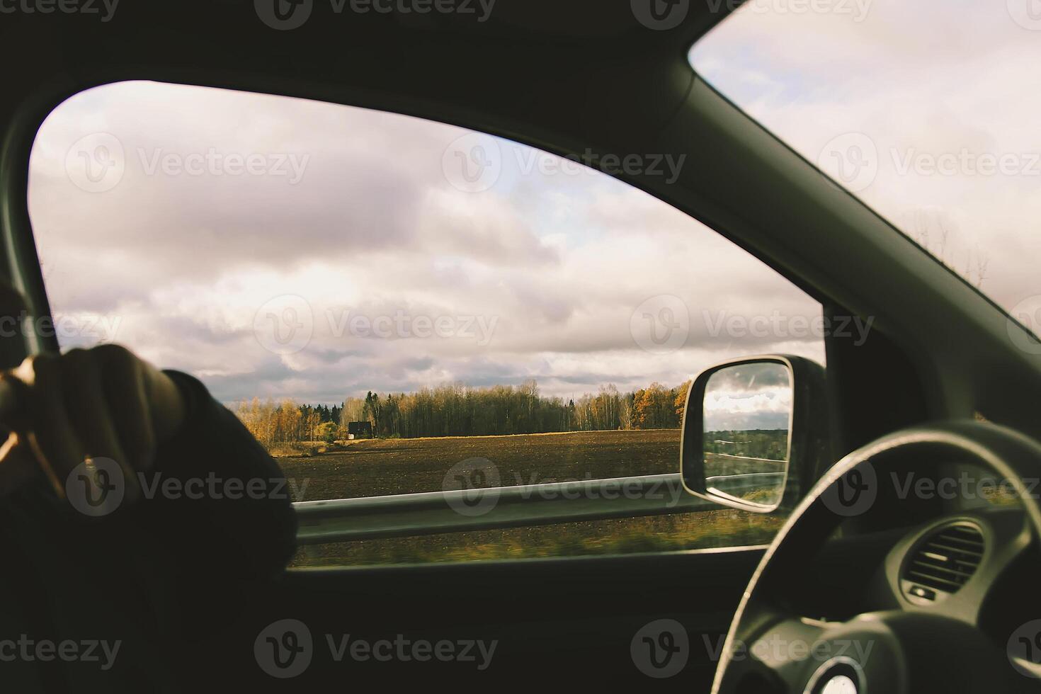Man drives a car. View through the moving car windscreen. photo
