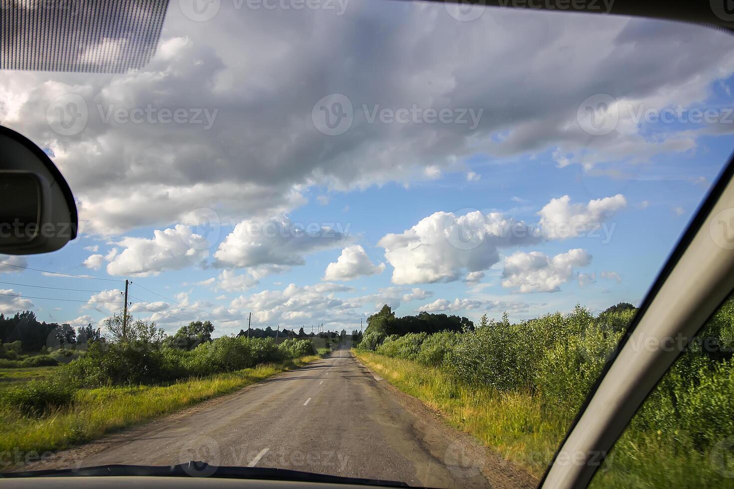 View of forest road through car glass. photo