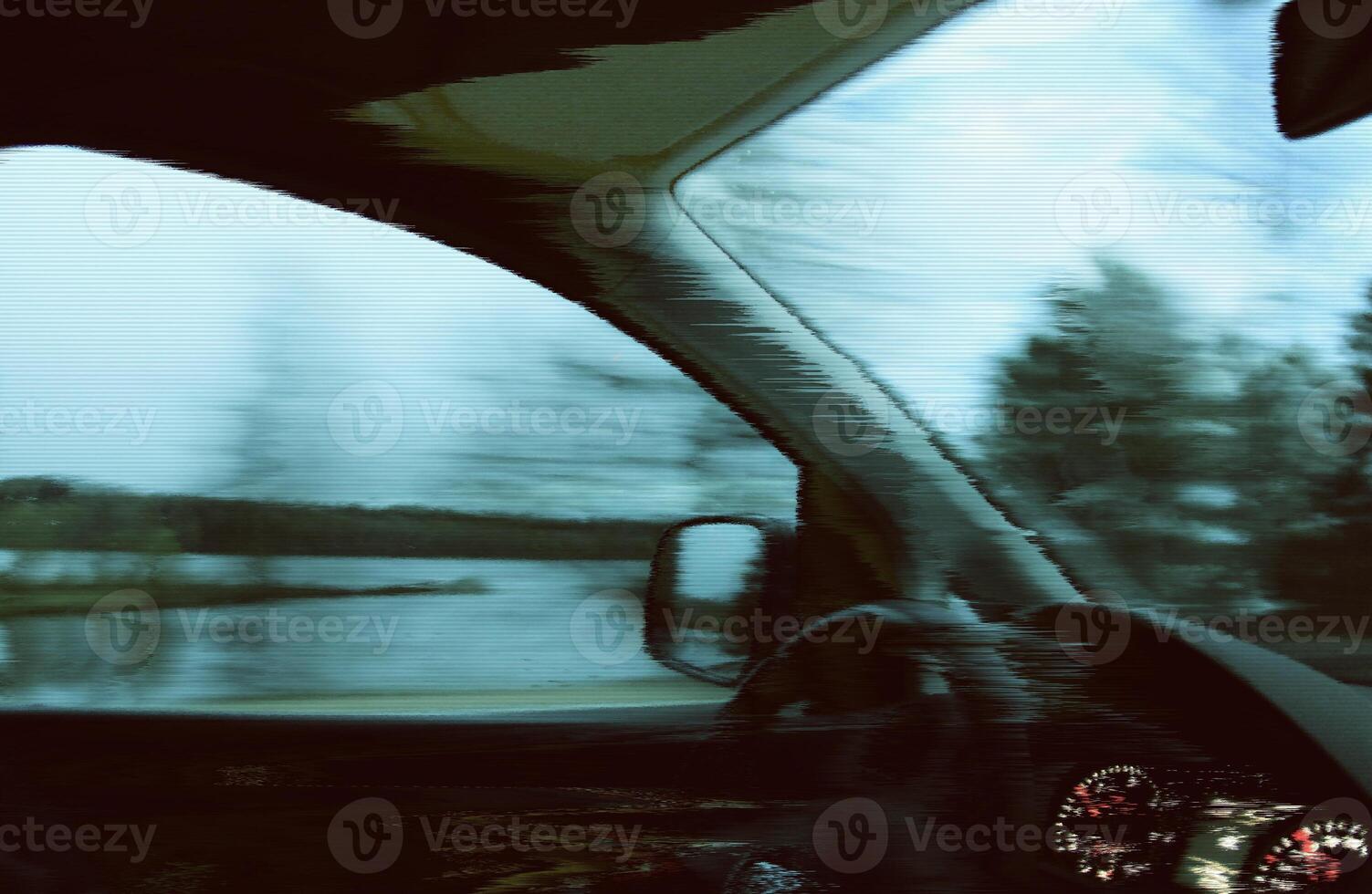 Blurred unfocused view through the moving car windscreen. Glitch retro effect. photo