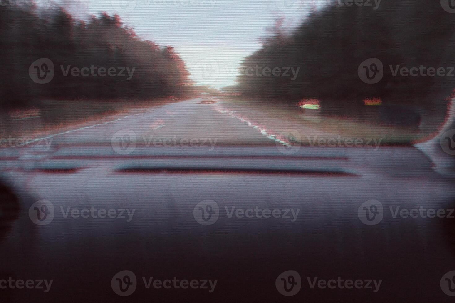 Blurred unfocused view through the moving car windscreen. Glitch retro effect. photo