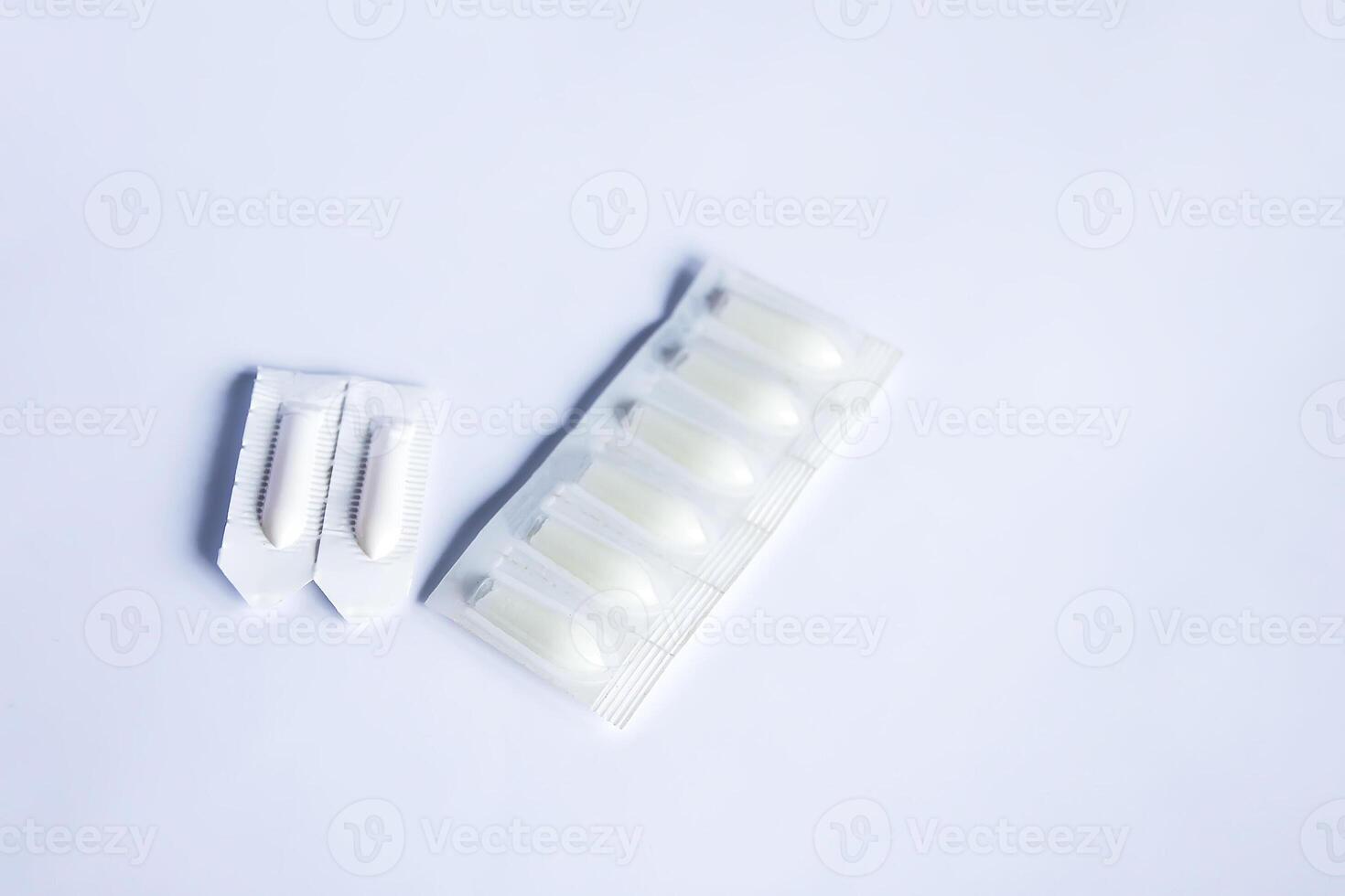 Pills and the medical candles on soft light background photo