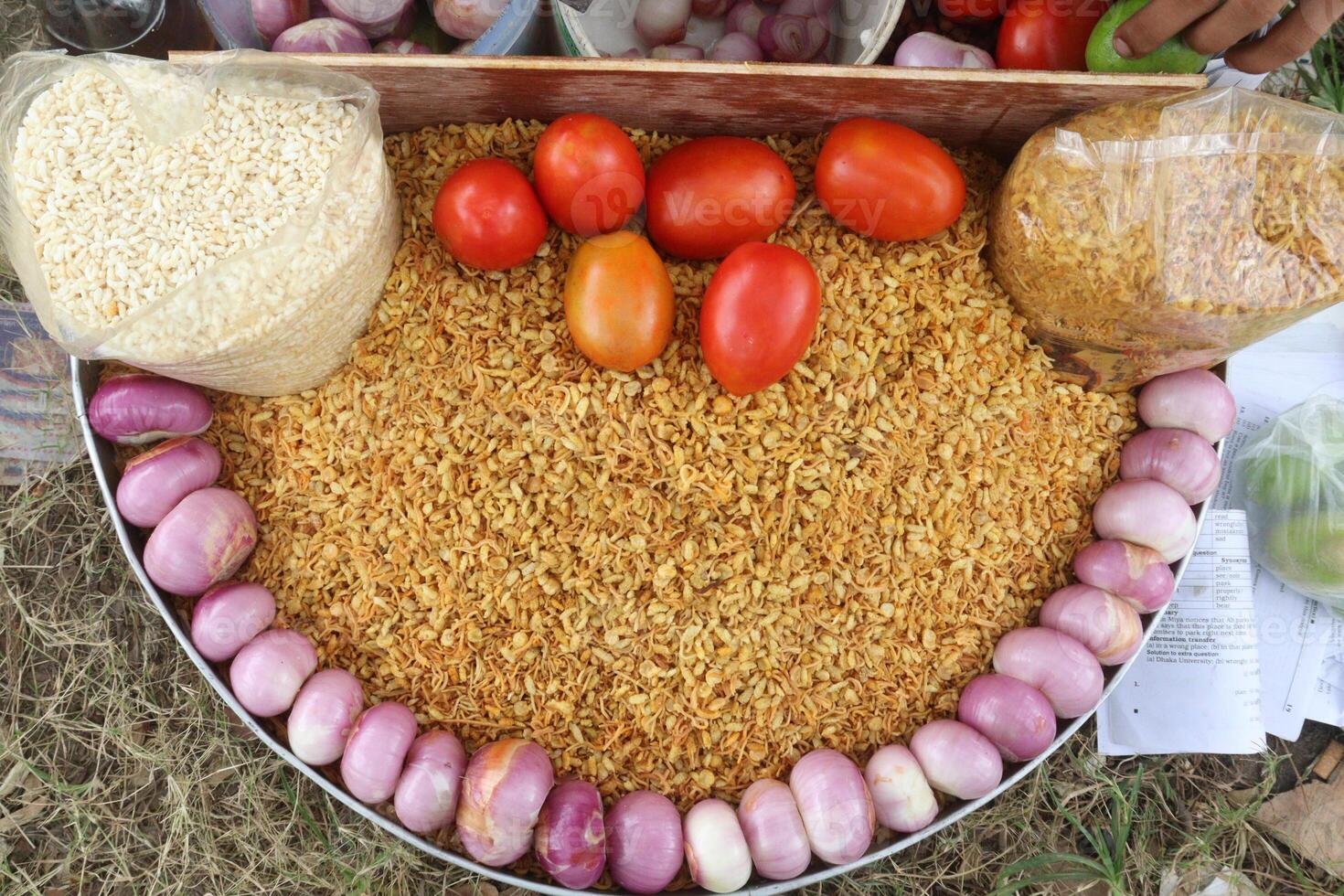 fried flattened rice and chanachur stock with onion, tomato, lemon photo