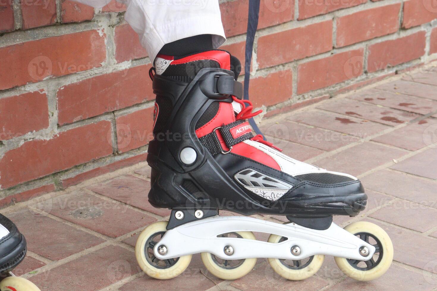 Inline Skates with leg on road photo