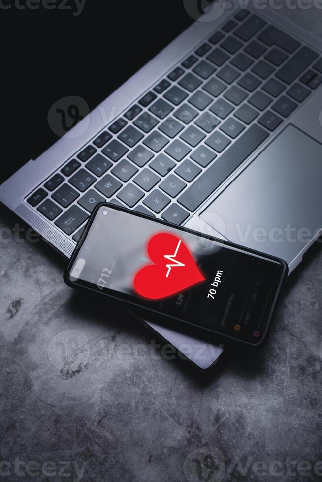 Smartphone with hologram screen interface showing beats per minute of user. Futuristic exercise app concept. photo
