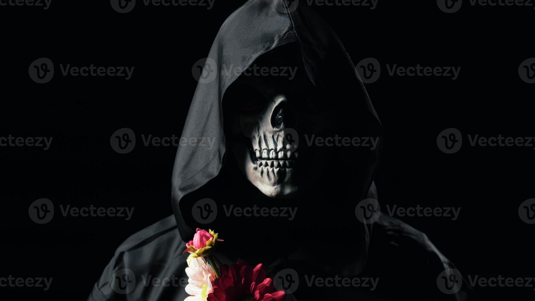 Dead man mask holding the flowers photo