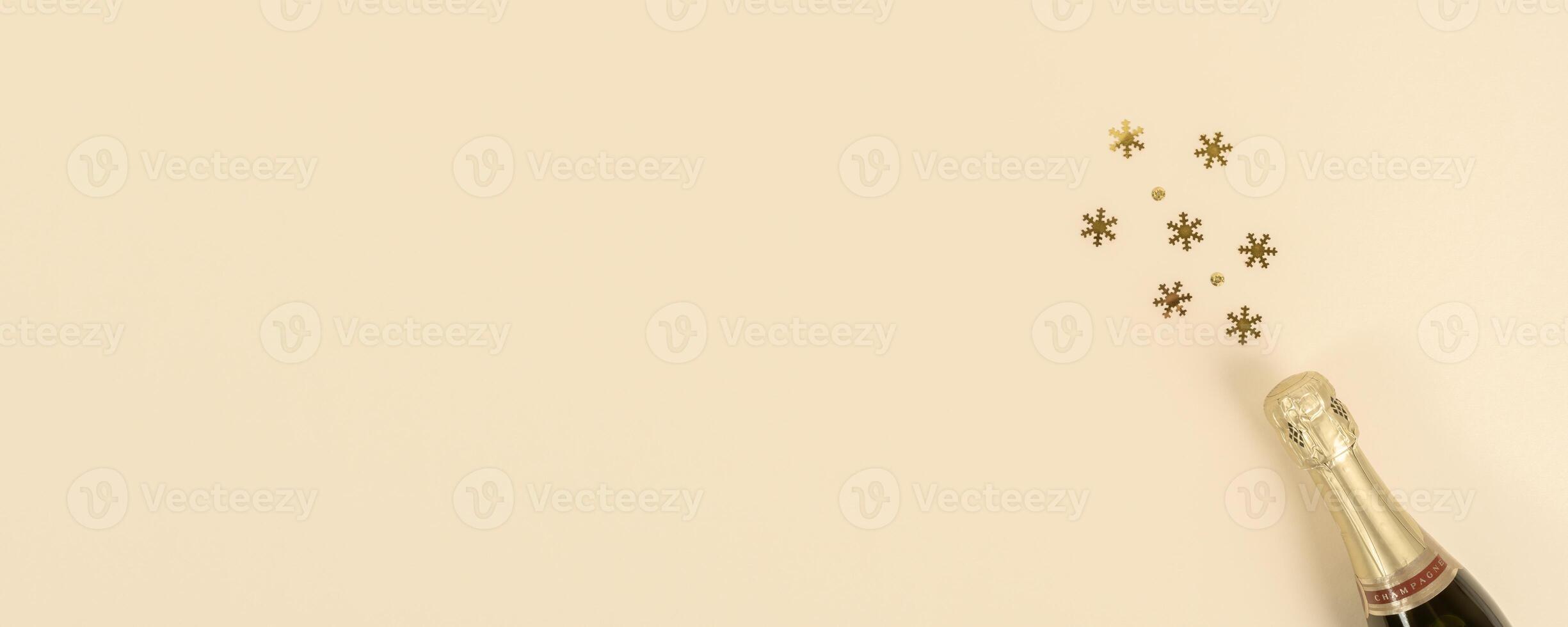Champagne bottle with confetti snowflakes. New Year, Christmas, celebration concept. Flat lay. Banner. Copy space photo