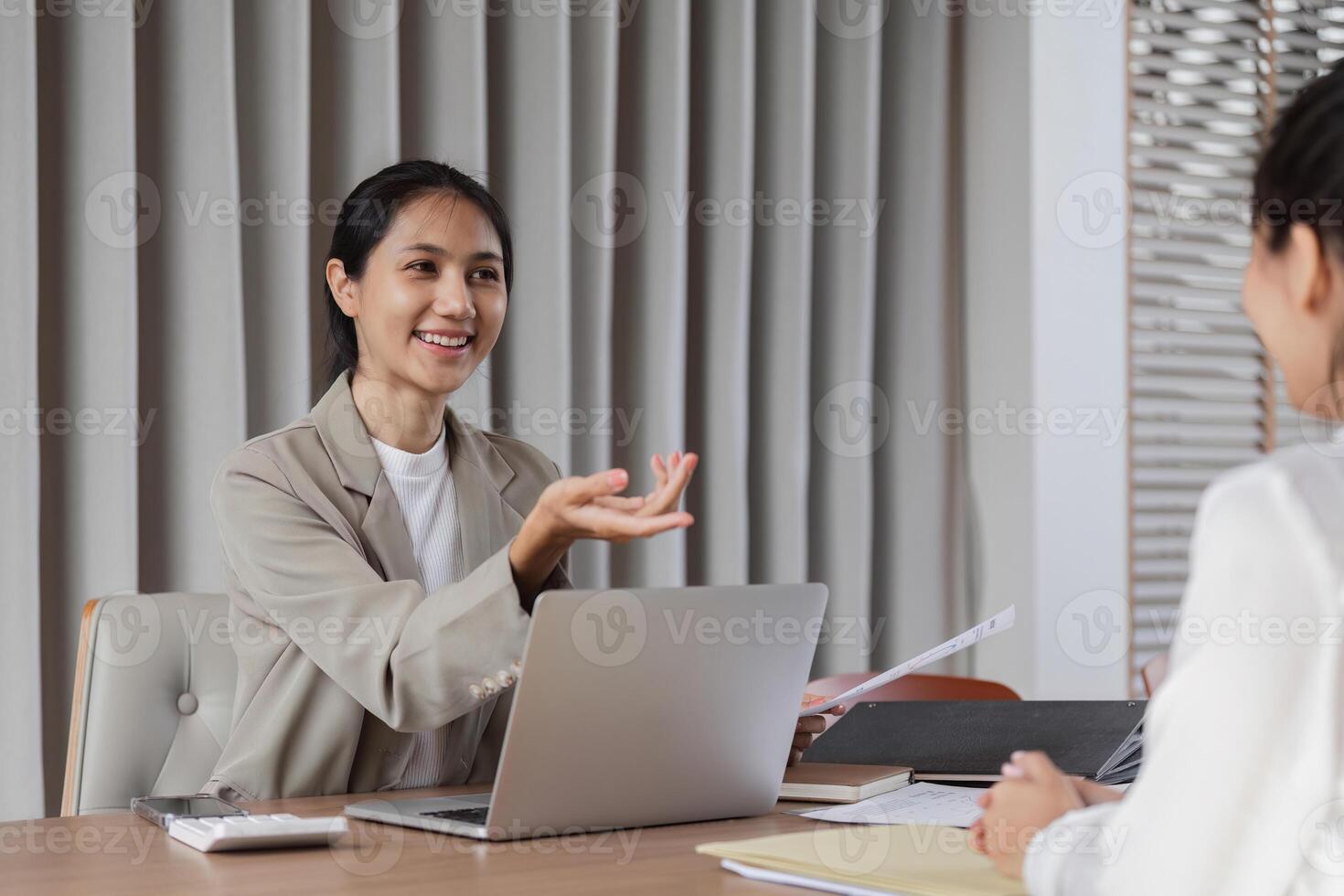 Business Team Engaged in Discussion and Consultation at Modern Office Workspace with Laptops and Documents photo