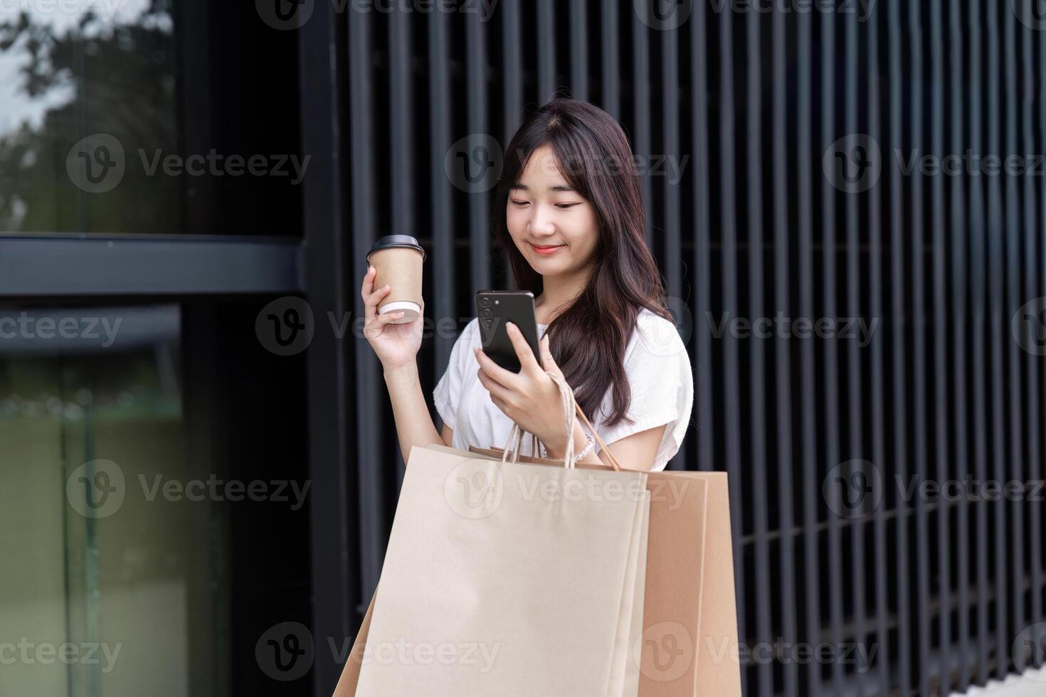 Young Woman Shopping with Paper Bag at Department Store, Smiling and Holding Coffee, Modern Lifestyle and Retail Experience photo