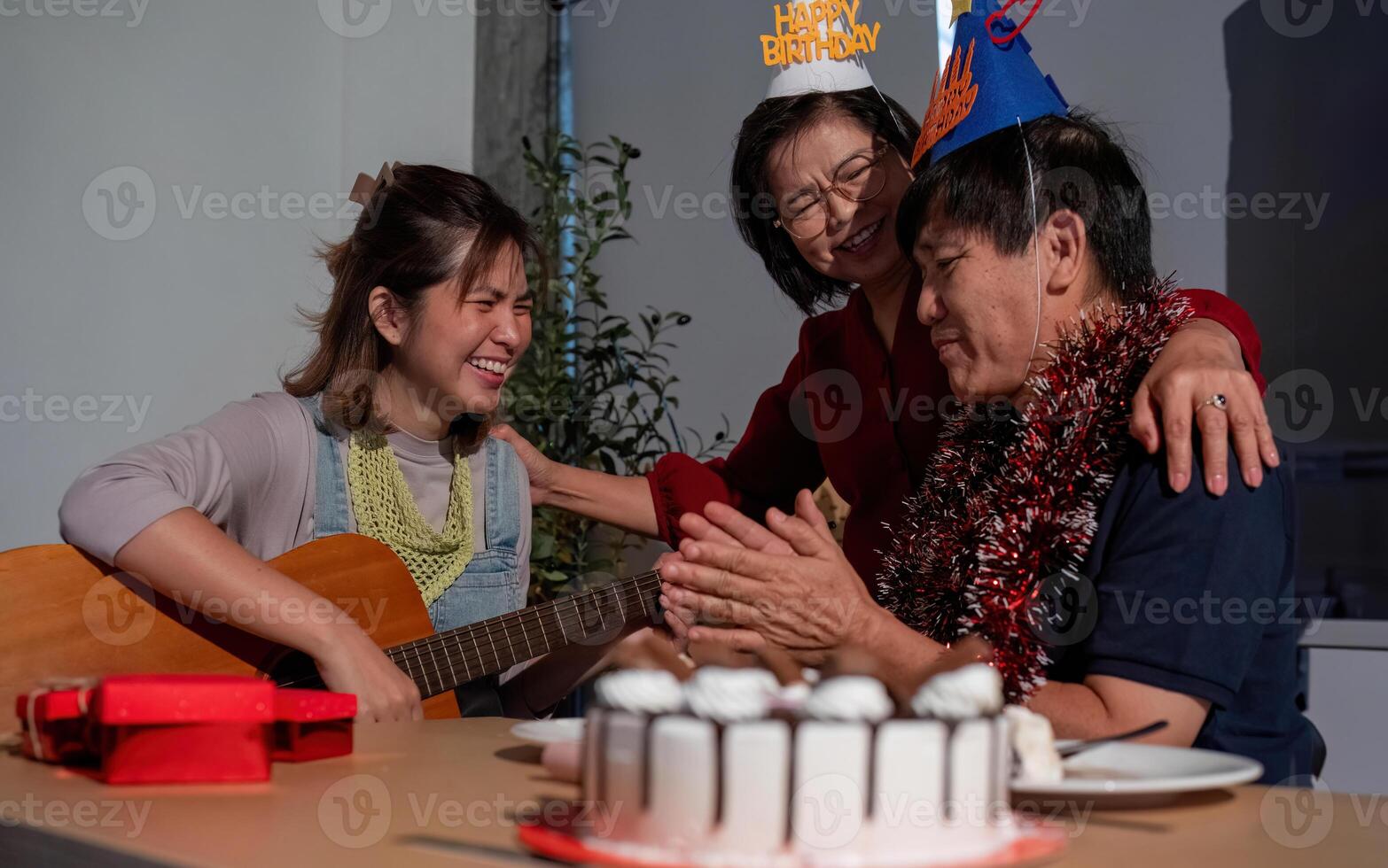 A man and two women are celebrating a birthday photo
