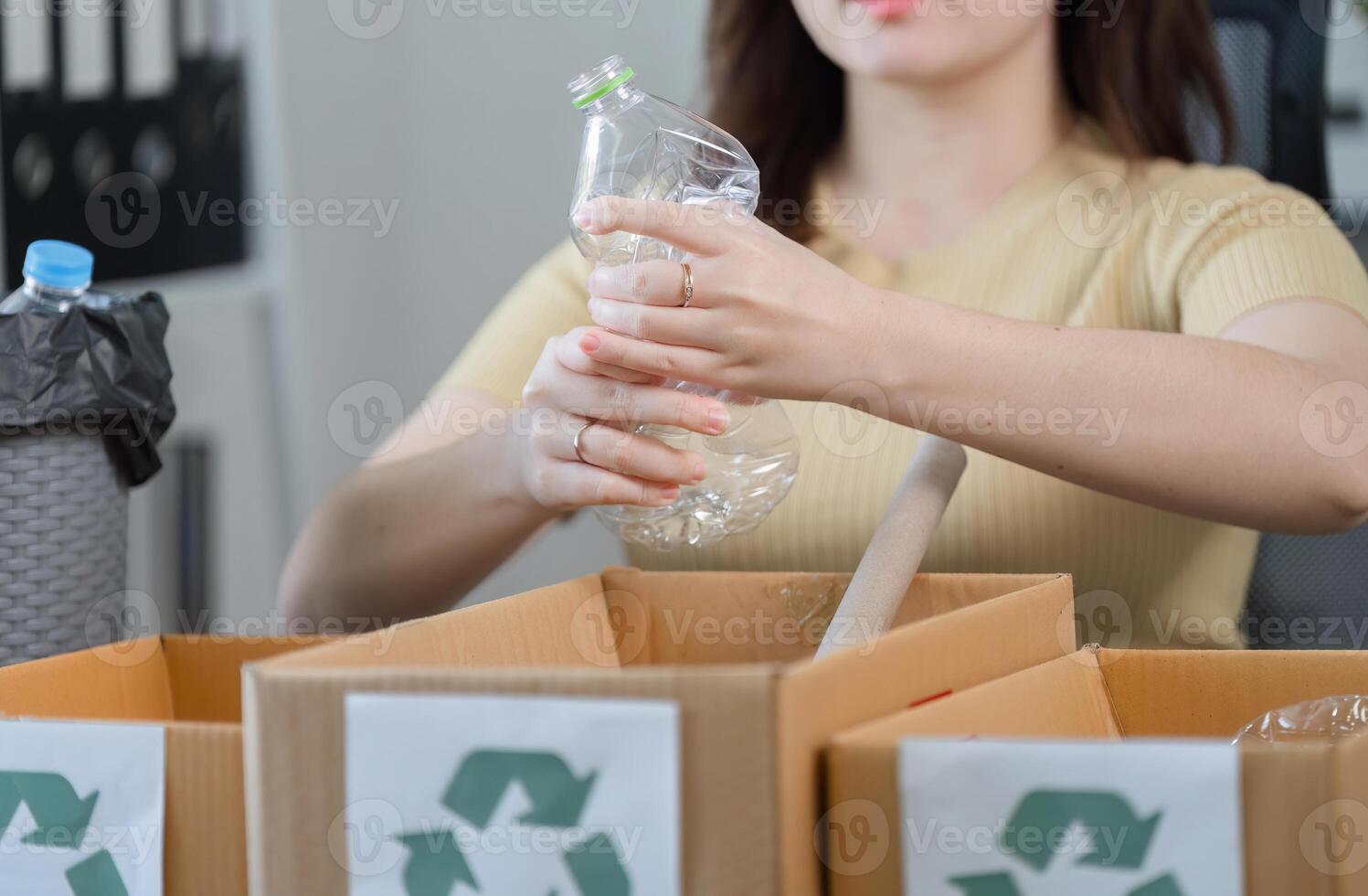 Young Woman Sorting Plastic Bottles for Recycling at Home to Promote Environmental Awareness and Sustainable Living Practices photo