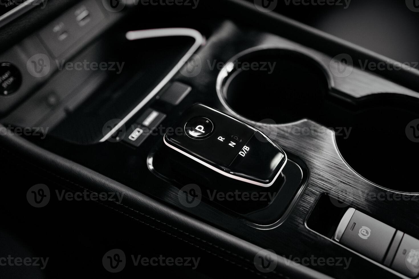 Modern car center console with electronic gear selector, stylish design, and control buttons. Ideal for automotive content, advertising, and blogs, highlighting comfort and technology photo