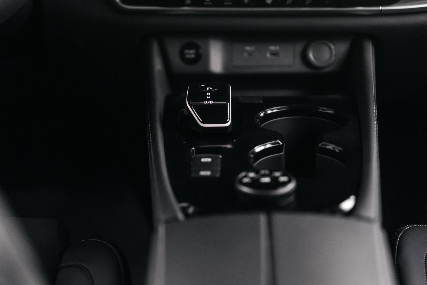 Modern car center console with electronic gear selector, stylish design, and control buttons. Ideal for automotive content, advertising, and blogs, highlighting comfort and technology photo
