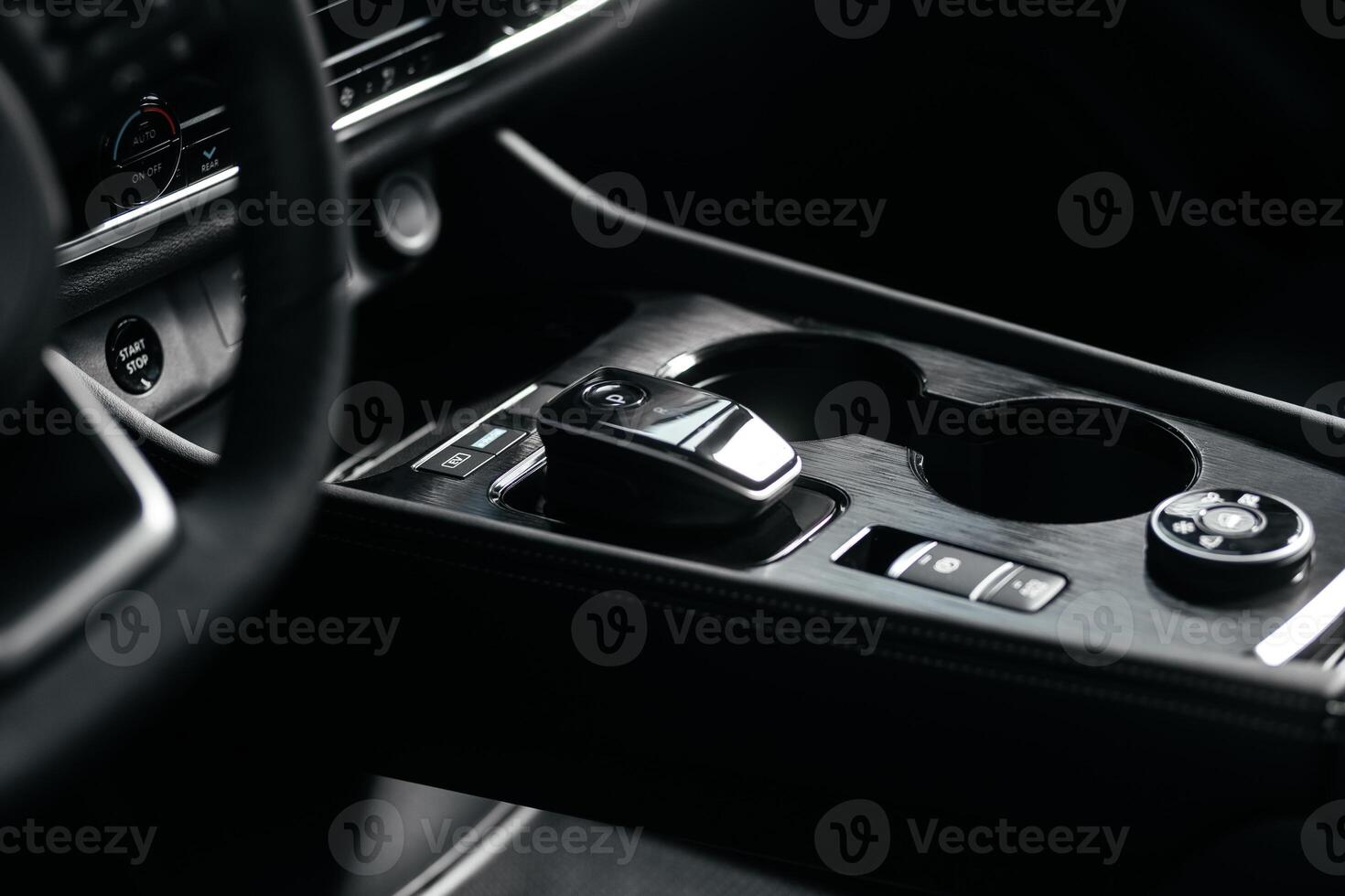 Modern car center console with electronic gear selector, stylish design, and control buttons. Ideal for automotive content, advertising, and blogs, highlighting comfort and technology photo