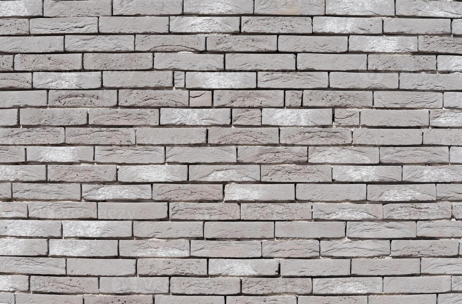 Gray textured brick wall, long and narrow modern bricks, horizontal decorative masonry, Textured stone background, brickwork outside new building, photo