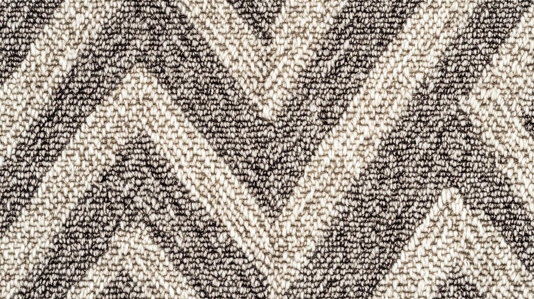A piece of fabric with a zigzag pattern. The fabric is black and white. The zigzag pattern is very prominent and the fabric is very soft. photo