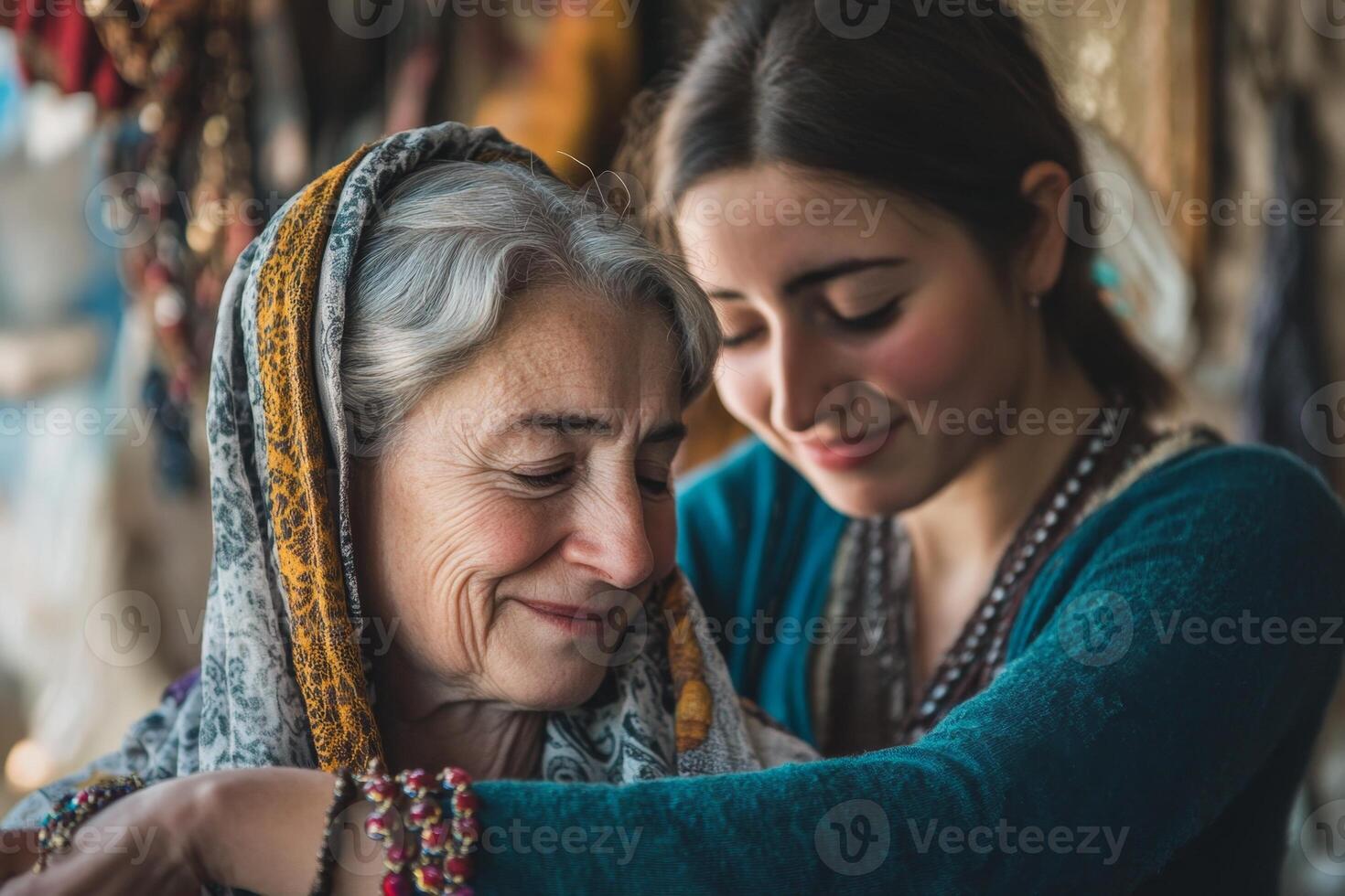Young woman helping senior woman trying on necklace in shop photo