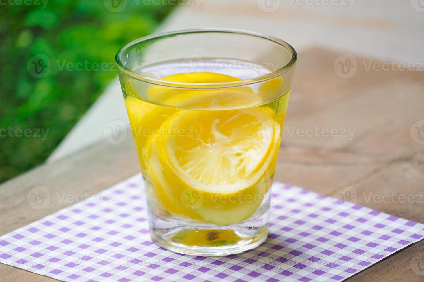 a glass of water lemon photo