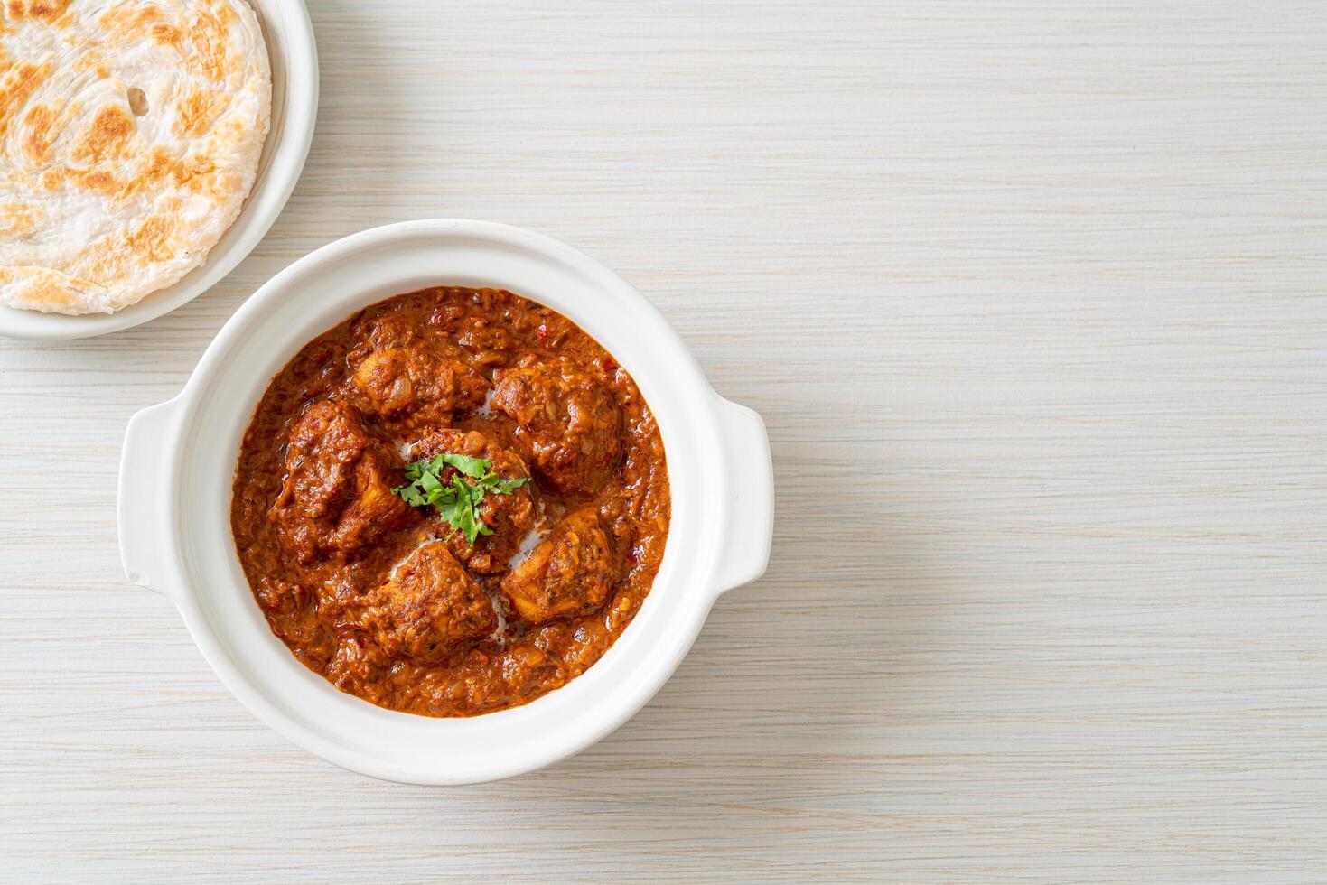 chicken tikka masala spicy curry meat food with roti or naan bread photo