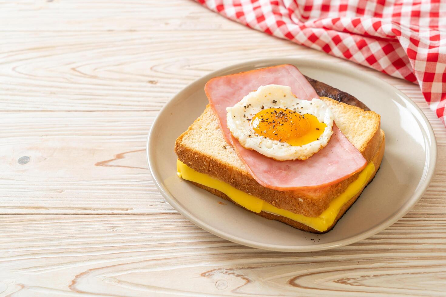 bread toasted cheese topped ham and fried egg with pork sausage photo