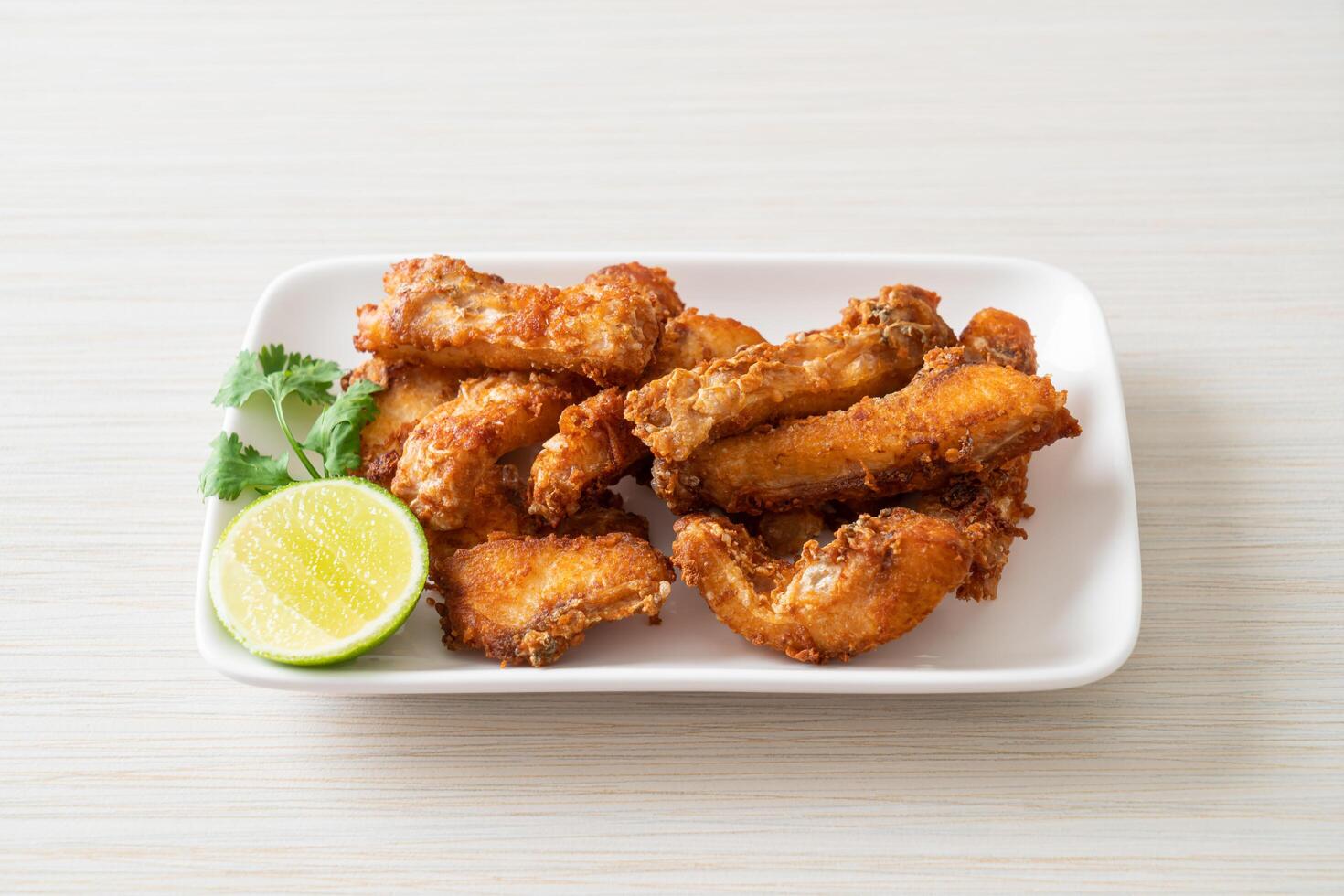 Fried Snapper Belly on white plate photo
