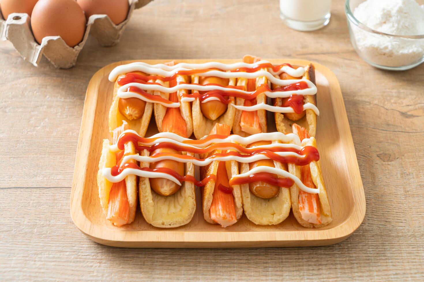 flat pancake roll with sausage and crab stick photo